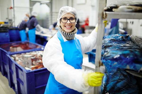 A female worker in a seafood processing facility